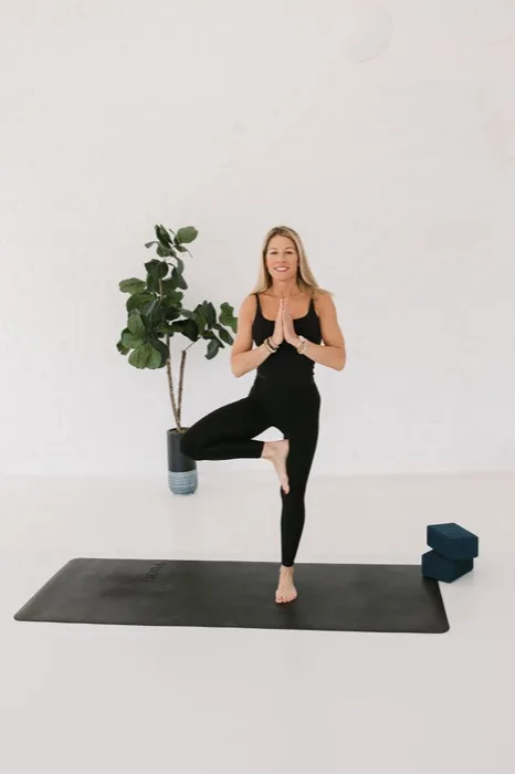 Cindia Norton, owner of Studio143, in a tree pose yoga stance